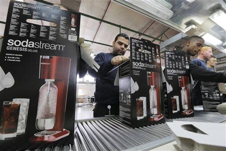 Employees pack boxes of the SodaStream product at the factory in the West Bank Jewish settlement of Maale Adumim January 28, 2014. REUTERS/Ammar Awad