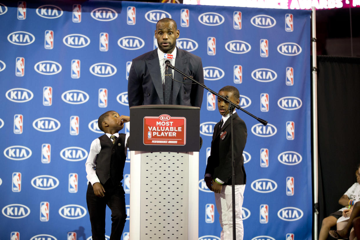 Bryce, left, and LeBron Jr. listen to their father as he accepts the 2013 NBA MVP award. (AP)