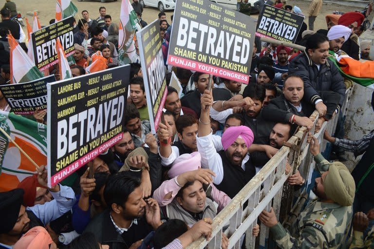 Indian Border Security Force soldiers confront activists during a protest over the death of two Indian soldiers in disputed Kashmir, at the Wagah border crossing on January 14, 2013. A ceasefire has taken hold in disputed Kashmir after the Indian and Pakistani armies agreed to halt deadly cross-border firing that had threatened to unravel a fragile peace process