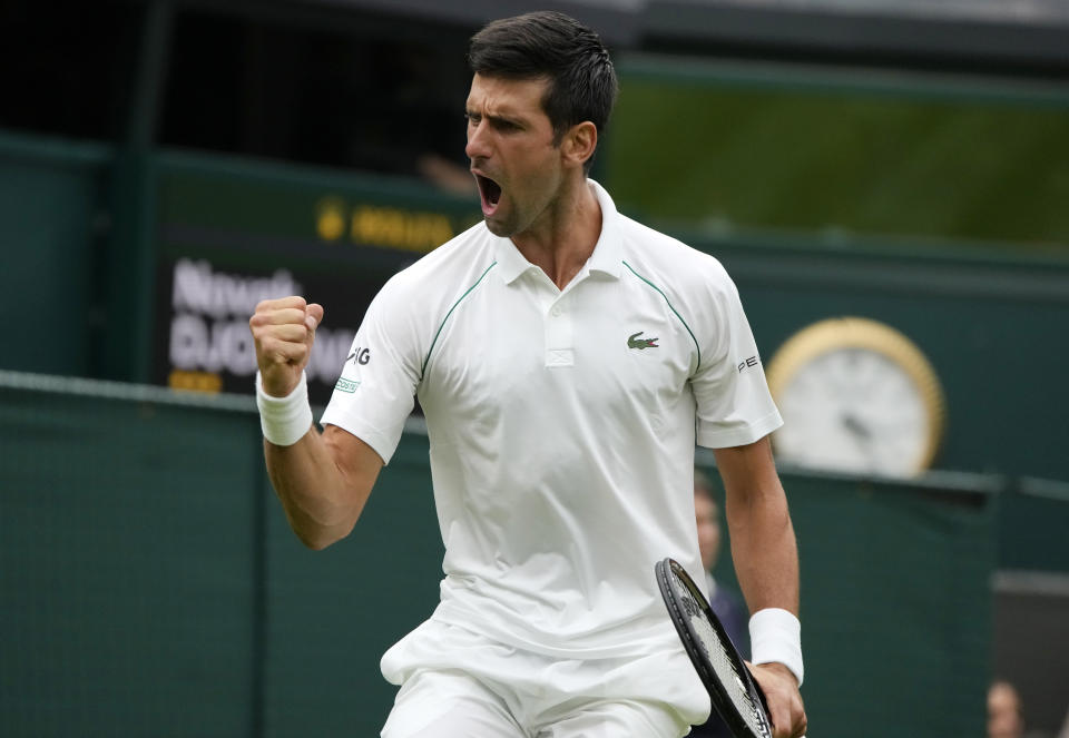 Serbia's Novak Djokovic celebrates during the men's singles match against Britain's Jack Draper on day one of the Wimbledon Tennis Championships in London, Monday June 28, 2021. (AP Photo/Kirsty Wigglesworth)