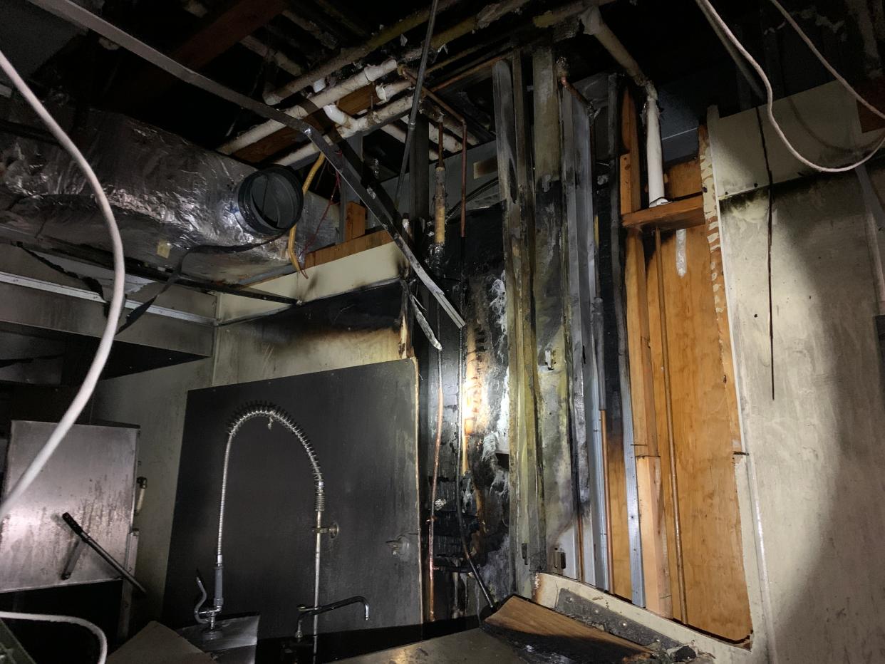 Fire damage is seen inside of a section of wall in the kitchen area at Happy Moose Bar and Grill on Route 14 in Streetsboro on Jan. 21. The cause of the fire has been determined to be accidental, resulting from heat from a grill drying and decomposing plywood within the wall, causing it to become combustible.