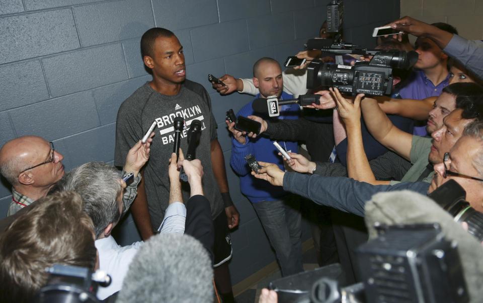 Brooklyn Nets center Jason Collins talks to reporters before the Nets faced the Denver Nuggets in an NBA basketball game in Denver on Thursday, Feb. 27, 2014. (AP Photo/David Zalubowski)