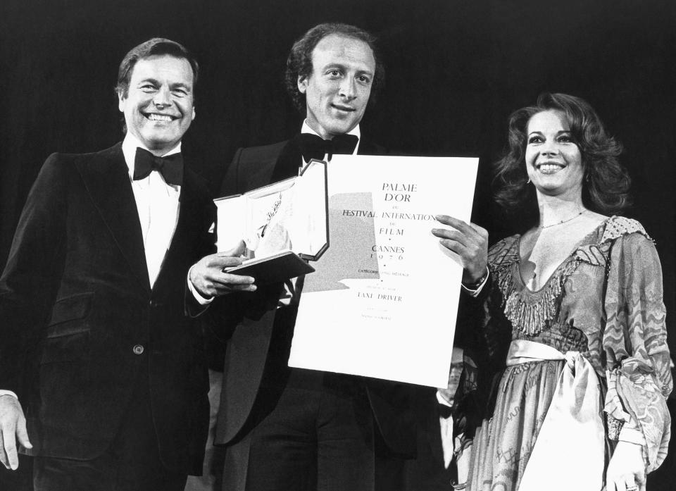 FILE - Actors Robert Wagner, left, and Natalie Wood, right, with producer Michael Philips who received the Golden Palm for the film "Taxi Driver" at the Cannes International Film Festival in France, May 31, 1976. When Martin Scorsese premieres his latest film, "Killers of the Flower Moon," at the Cannes Film Festival on May 20th, it will return Scorsese to a festival where he remains a part of its fabled history. (AP Photo/Jean-Jacques Levy, File)