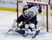 Winnipeg Jets center Mason Appleton screens Ottawa Senators goaltender Anton Forsberg on a shot during second period NHL action Monday, April 12, 2021, in Ottawa, Ontario. (Adrian Wyld/The Canadian Press via AP)