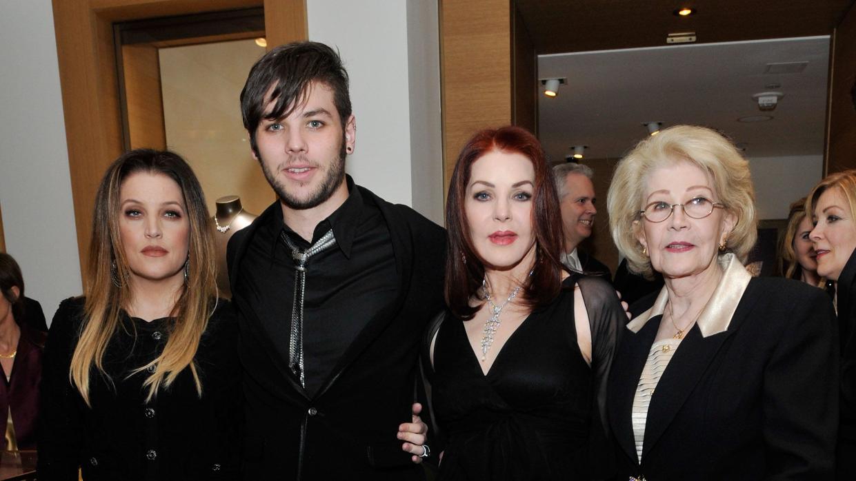 navarone garibaldi standing for a photo between half sister lisa marie presley and mother priscilla presley