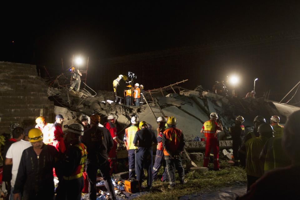 Emergency workers search for survivors after a building collapsed in Tongaat, north of Durban, November 19, 2013. At least one person was killed and up to 50 more were trapped under rubble on Tuesday after a half-built shopping mall collapsed near the South African coastal city of Durban, emergency services and police said. A further 26 people had been taken to hospital in the town of Tongaat, 30 km (20 miles) north of Durban, Chris Botha, a spokesman for the Netcare 911 emergency service, told Reuters. REUTERS/Rogan Ward (SOUTH AFRICA - Tags: DISASTER)