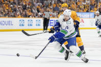 Vancouver Canucks center Pius Suter (24) passes the puck past Nashville Predators center Colton Sissons (10) during the first period in Game 6 of an NHL hockey Stanley Cup first-round playoff series Friday, May 3, 2024, in Nashville, Tenn. (AP Photo/George Walker IV)