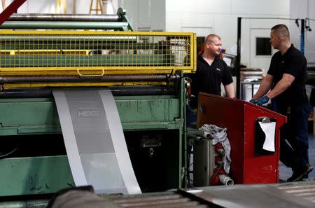 Workers at perforating company Bion feed a piece of metal into a machine at the factory in Reading, Britain September 22, 2016. REUTERS/Peter Nicholls