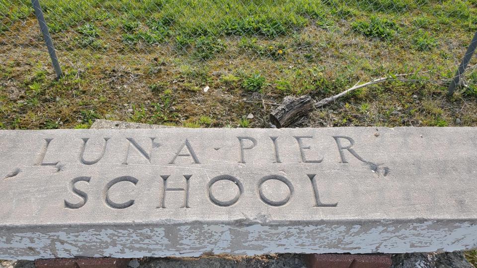 The header of the Luna Pier School, opened in 1936, is pictured. The school served well into the early 2000s and was officially closed in 2006.