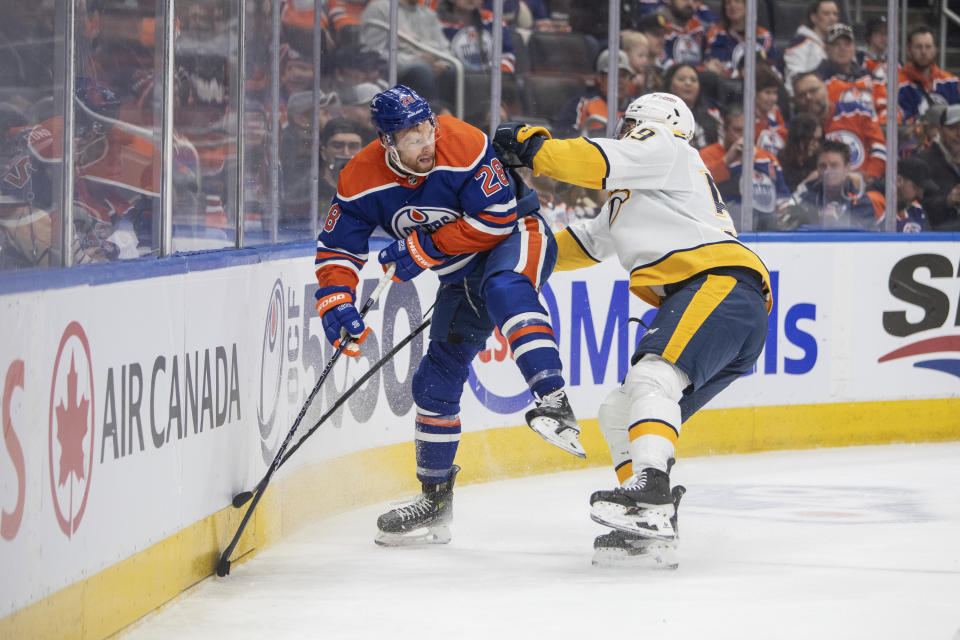 Nashville Predators' Roman Josi (59) checks Edmonton Oilers' Connor Brown (28) during second-period NHL hockey game action in Edmonton, Alberta, Saturday, Jan. 27, 2024. (Amber Bracken/The Canadian Press via AP)