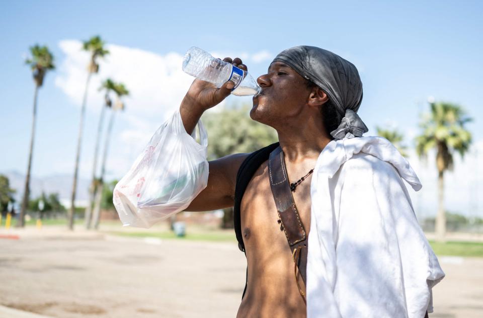 Alonzo McAdams drinks a bottle of water given to him from a Salvation Army truck handing out water, and other supplies for the homeless in Tucson, Arizona on July 26, 2023 during a record-breaking heat wave across the southern United States. Photo by ANDREW CABALLERO-REYNOLDS / AFP via Getty Images