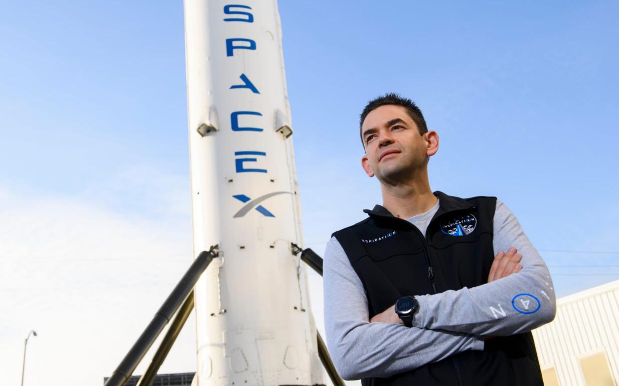 Jared Isaacman, founder and CEO of payments technology company Shift4 Payments is offering three seats on a SpaceX Crew Dragon rocket - PATRICK T. FALLON /AFP