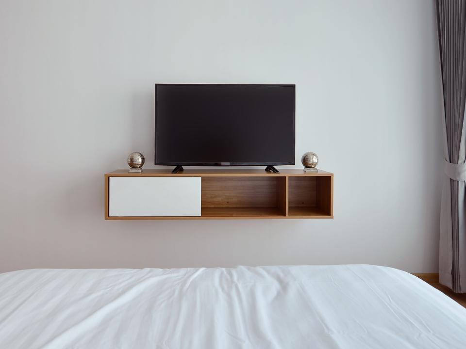 View of TV on shelf in bedroom