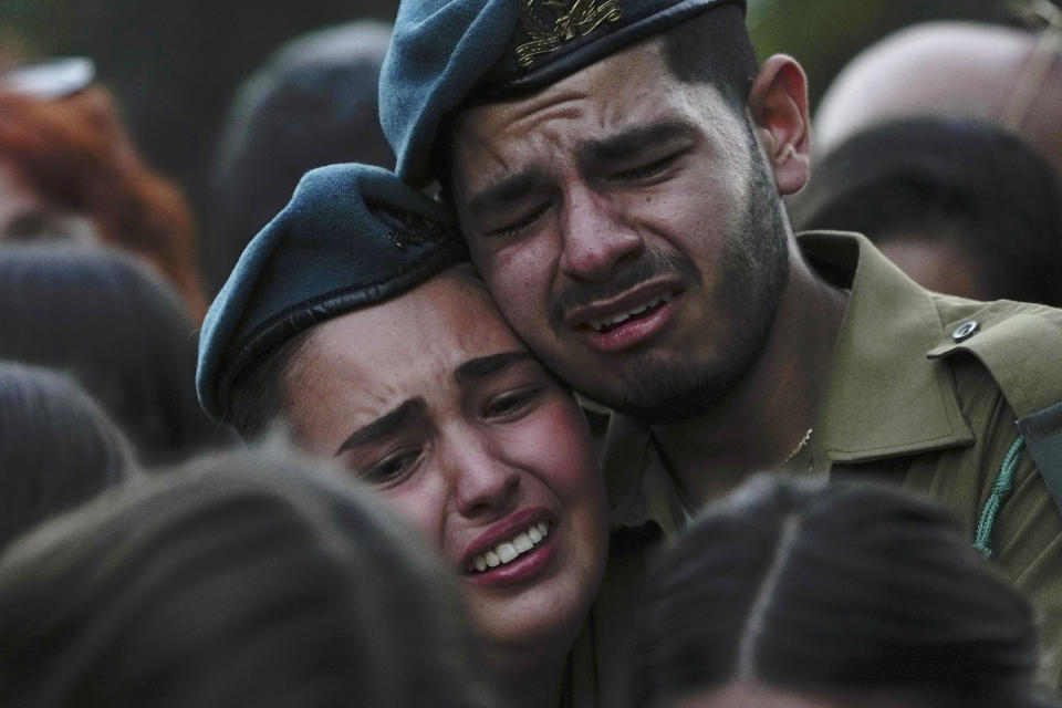 Israeli soldiers cry during the funeral of Sgt. Yam Goldstein and her father, Nadav, in Kibbutz Shefayim, Israel, Monday, Oct. 23, 2023. Yam and her father were killed by Hamas militants on Oct. 7 at their house in Kibbutz Kfar Azza near the border with the Gaza Strip. The rest of the family are believed to be held hostage in Gaza. (AP Photo/Ariel Schalit)