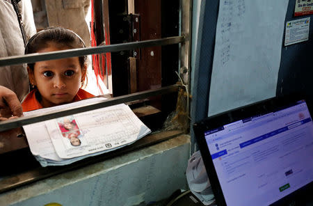 A girl waits for her turn to enrol for the Unique Identification (UID) database system, also known as Aadhaar, at a registration centre in New Delhi, India, January 17, 2018. Picture taken January 17, 2018. REUTERS/Saumya Khandelwal