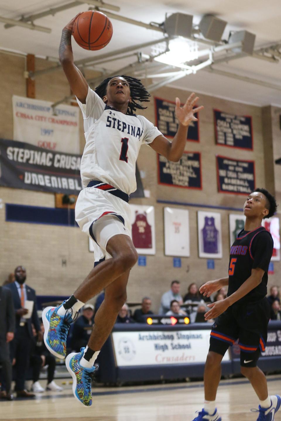 Stepinac's Boogie Fland (1) goes up for a shot against Saint Raymond during boys basketball action at Stepinac High School in White Plains Jan. 20, 2023. Stepinac won the game 89-87 in overtime. Fland finished the game with 40-points.