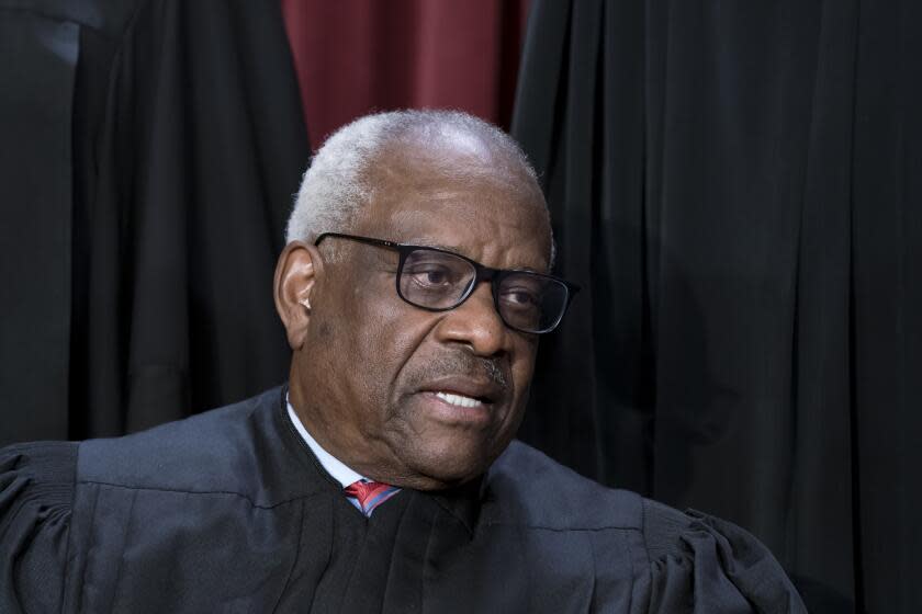 Associate Justice Clarence Thomas joins other members of the Supreme Court as they pose for a new group portrait, at the Supreme Court building in Washington, Friday, Oct. 7, 2022. Justice Thomas was nominated by President George H. W. Bush to succeed Justice Thurgood Marshall and has served since 1991. (AP Photo/J. Scott Applewhite)