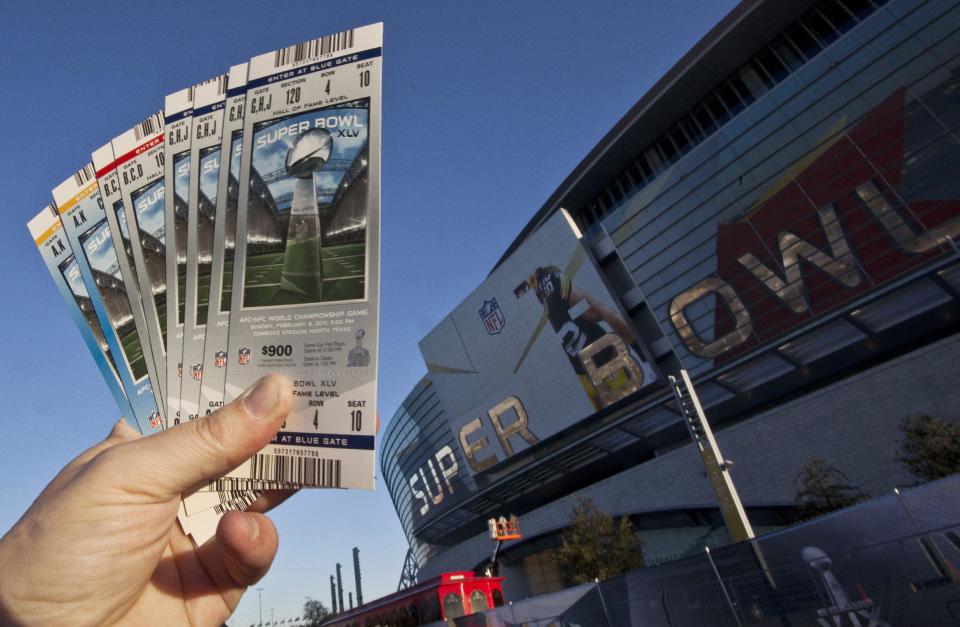 FILE - In this Jan. 28, 2011, file photo, some NFL football Super Bowl XLV tickets are held outside Cowboys Stadium in Arlington, Texas. Super Bowl tickets are tough to acquire. There's only so many seats in the stadium, and several are filled by corporations and sponsors. Then, when you factor in price and logistics, it makes it all that more difficult, even with the rise of the secondary market on the internet. Things won't be any easier this year, as the NFL houses its first cold-weather Super Bowl on Feb. 2 at MetLife Stadium with the New York skyline as a backdrop. (AP Photo/Morry Gash, File)