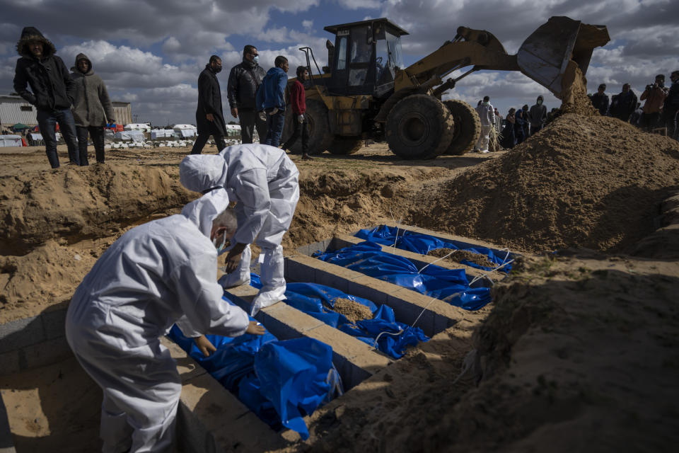 Palestinians bury the bodies of people who were killed in fighting with Israel and returned to Gaza by the Israeli military, during a mass funeral in Rafah, Gaza Strip, Tuesday, Jan. 30, 2024. (AP Photo/Fatima Shbair)