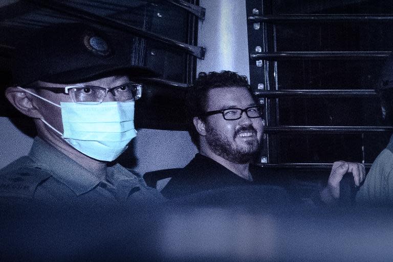 British banker Rurik Jutting (R), pictured here leaving a court hearing on November 10, 2014, is charged with the gruesome murders of two young Indonesian women whose bodies were found in his apartment