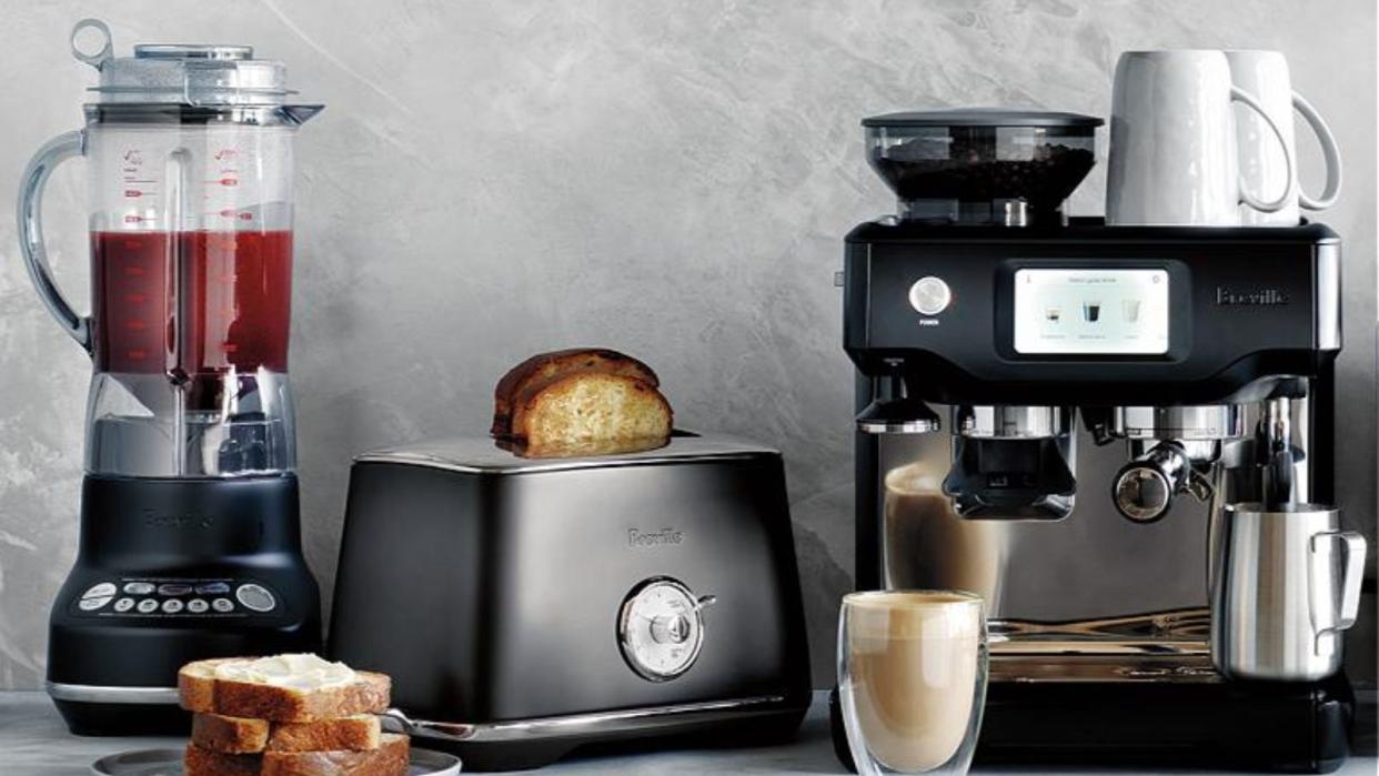  Breville vs Sage: some Breville kitchen appliances: a toaster, espresso machine, and blender on a countertop. 