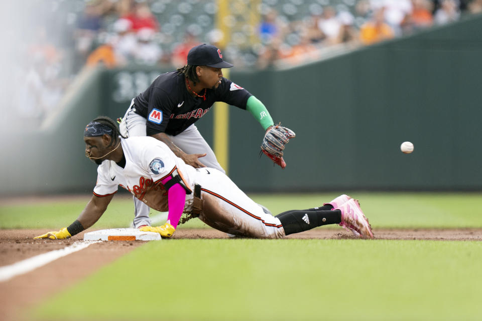 Baltimore Orioles' Jorge Mateo, right, slides into third base in front of Baltimore Orioles third baseman Jordan Westburg, left, after hitting a triple during the second inning of a baseball game, Tuesday, June 25, 2024, in Baltimore. (AP Photo/Stephanie Scarbrough)