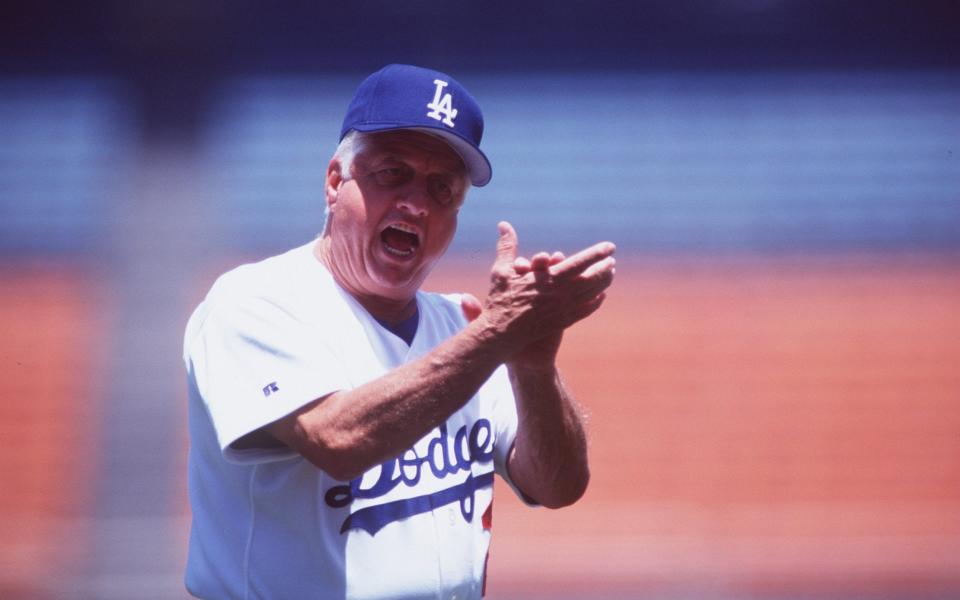 Lasorda applauds his players during a game in 1995 - JD Cuban/Allsport