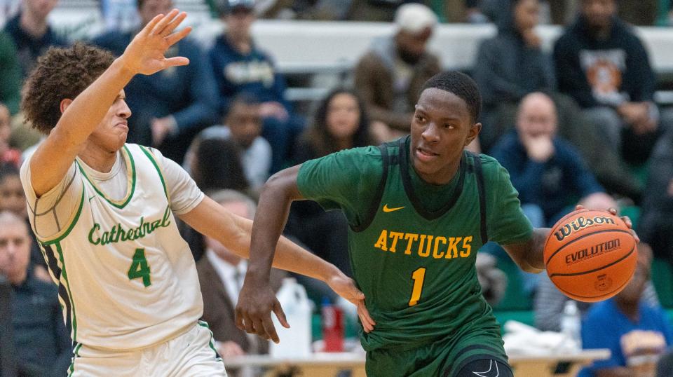 Cathedral High School's Deric Cannady defends Indianapolis Crispus Attucks High School's Chris Hurt  during the boys Indianapolis city championship, Monday, Jan. 23, 2023, won by Crispus Attucks 61-51. 