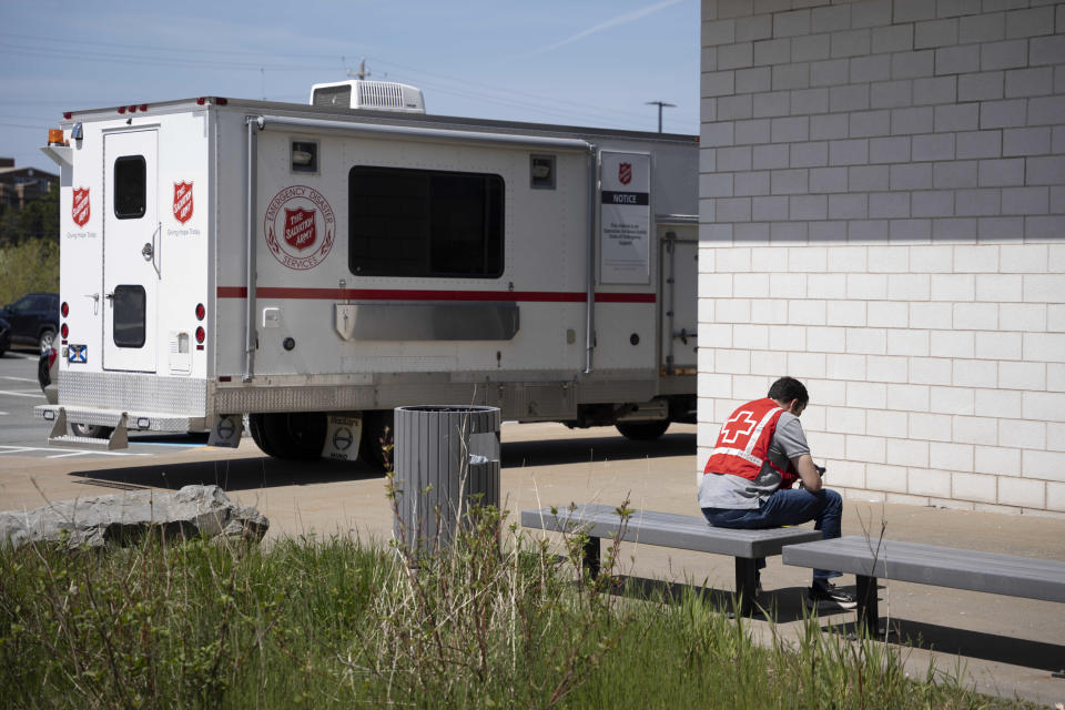 A volunteer with the Salvation Army's Emergency and Disaster Services takes a break while working at an evacuation centre where food and shelter is being provided for those forced from their homes due to the wildfire burning in suburban Halifax, Nova Scotia, on Tuesday, May 30, 2023. (Darren Calabrese/The Canadian Press via AP)
