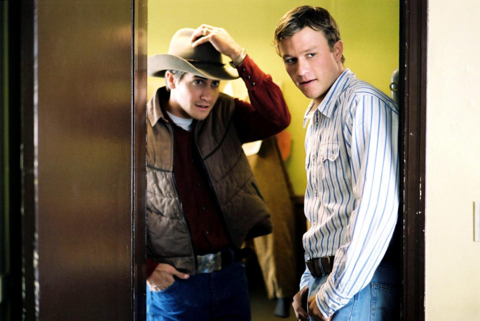 Jake Gyllenhaal and Heath Ledger standing together in a doorway