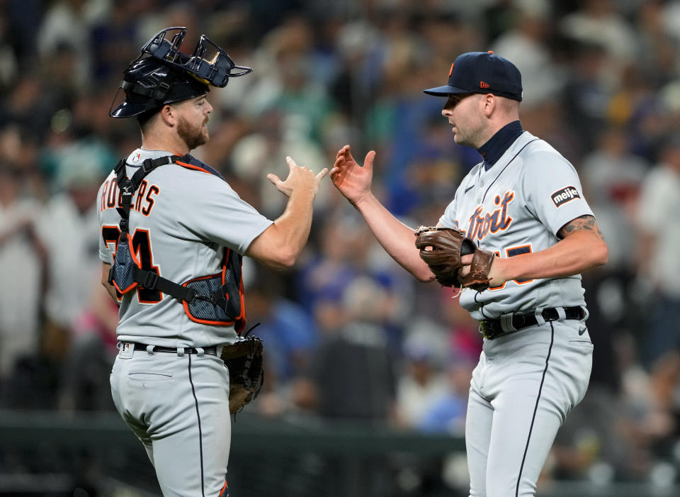 Detroit Tigers catcher Jake Rogers, left, congratulates relief pitcher Alex Lange, who earned a save in the team's 5-4 win over the Seattle Mariners in a baseball game Friday, July 14, 2023, in Seattle. (AP Photo/Lindsey Wasson)