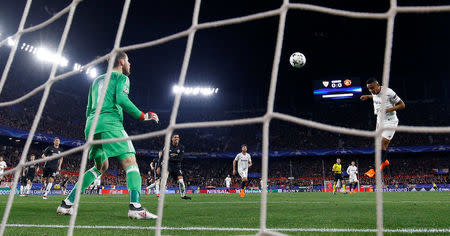 Soccer Football - Champions League Round of 16 First Leg - Sevilla vs Manchester United - Ramon Sanchez Pizjuan, Seville, Spain - February 21, 2018 Sevilla’s Luis Muriel shoots at goal with a header which is saved by Manchester United's David De Gea REUTERS/Juan Medina