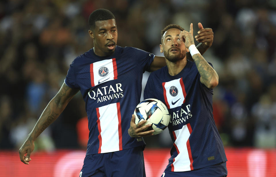 PSG's Presnel Kimpembe, left, and PSG's Neymar celebrate after scoring during the French League One soccer match between Paris Saint-Germain and Monaco at the Parc des Princes in Paris, France, Sunday, Aug. 28, 2022. (AP Photo/Aurelien Morissard)