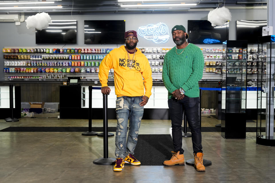 Cloud 9 Cannabis co-owner and CEO Sam Ward Jr., left, and co-owner Dennis Turner, right, pose at their shop, Thursday, Feb. 1, 2024, in Arlington, Wash. Cloud 9 is one of the first dispensaries to open under the Washington Liquor and Cannabis Board's social equity program, established in efforts to remedy some of the disproportionate effects marijuana prohibition had on communities of color. (AP Photo/Lindsey Wasson)