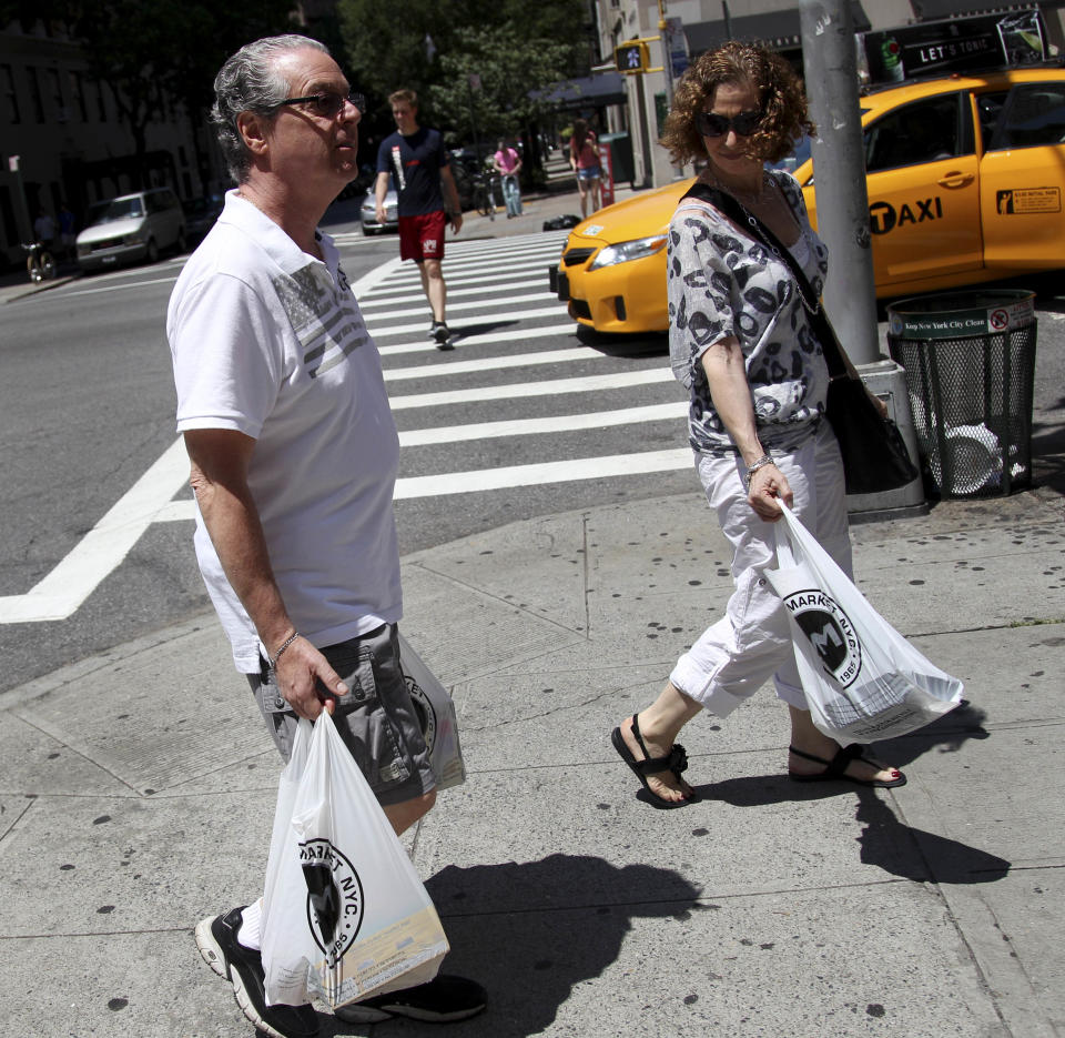 In this Sunday, July 8, 2012 photo, Jason Marder walks home with his wife, Karin Marder, after visiting a grocery store in New York. Jason Marder, who turned 70 on Tuesday, July 10, 2012, was diagnosed with Alzheimer's more than eight years ago. In the roughly five years that her husband has taken Gammagard, "there has been decline" in his health but it is very minimal and the kind of slowing down you might expect from ordinary aging, she said. "He travels the subways, he does things that you and I do. And our quality of life together is what's most important." (AP Photo/Seth Wenig)