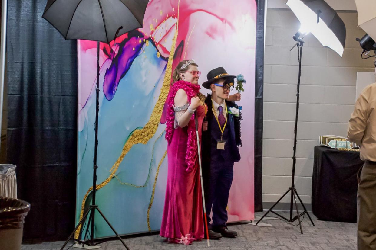 Guests pose for snapshots at the photo booth during Night to Shine. The evening featured a DJ, catering from Theo's and lots of dancing.