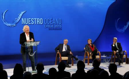 Richard Branson (L-R), founder of Virgin Group and Virgin Unite, delivers a speech as Chile's Foreign Minister Heraldo Munoz, Chile's President Michelle Bachelet and U.S. Secretary of State John Kerry listen during the "Our Ocean" conference in Vina del Mar city October 5, 2015. REUTERS/Rodrigo Garrido