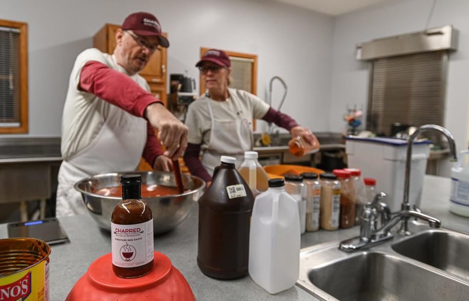 Rich and Trish Steffens of Charred Sauces and Seasonings prepare their "Charred" BBQ sauce, Wednesday, Dec. 6, 2023, in Laingsburg.