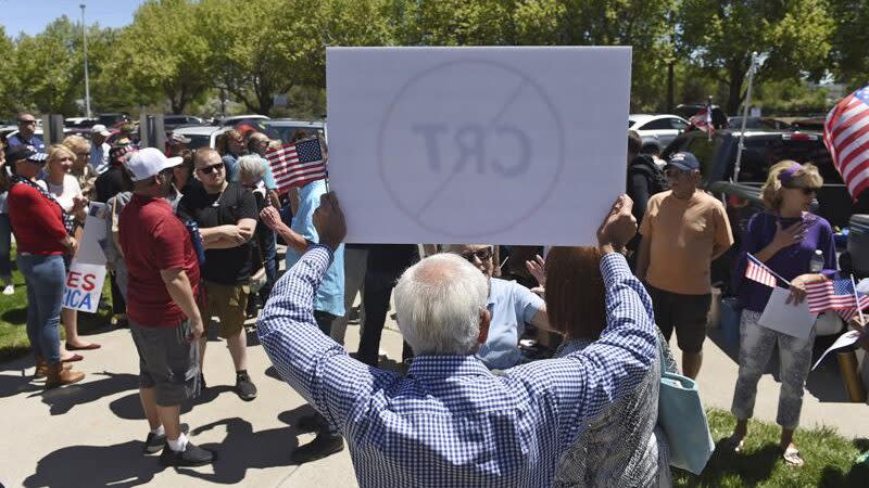 A man holds up a sign against Critical Race Theory during a protest outside a Washoe County School District board meeting on May 25, 2021, in Reno, Nev. (Andy Barron/Reno Gazette-Journal via AP)