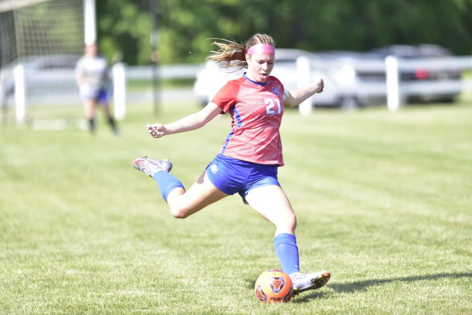 St. Clair's Ella Farkas kicks the ball downfield during the Saints' 8-1 win over Imlay City in a Division 2 district final at North Branch High School on Thursday.