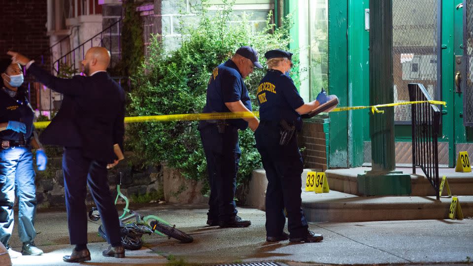 Investigators are seen at the site of Monday's mass shooting. - Tracie Van Auken/EPA-EFE/Shutterstock