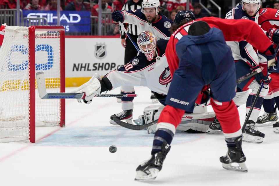 Washington Capitals left wing Sonny Milano (15) shoots the puck past Columbus Blue Jackets goaltender Elvis Merzlikins (90) to score during the first period of an NHL hockey game Saturday, Nov. 4, 2023, in Washington. (AP Photo/Jess Rapfogel)