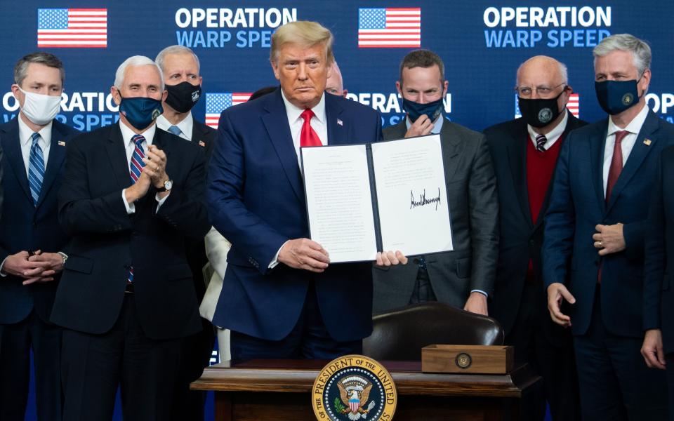 President Donald Trump holds a signed executive order during the Operation Warp Speed Vaccine Summit in Washington, D.C., on Dec. 8, 2020.