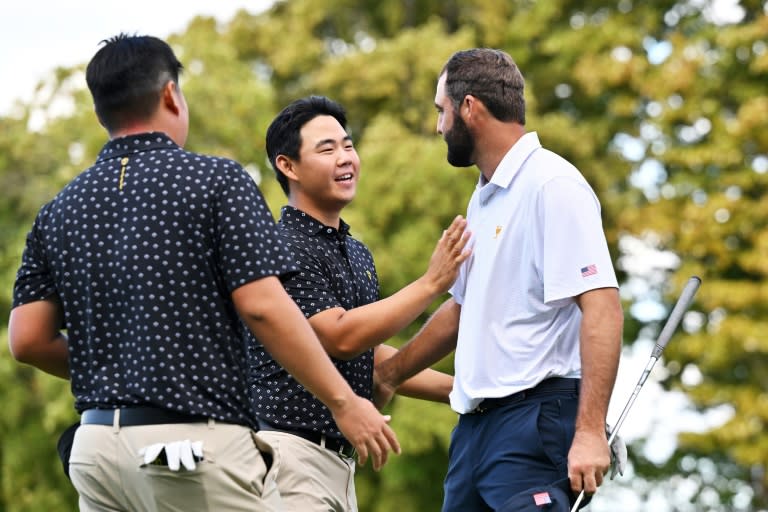 US star Scottie Scheffler, right, shakes hands with pal Tom Kim of South Korea after a US victory in a match that saw the friends trade verbal jibes after long birdie putts (Minas Panagiotakis)