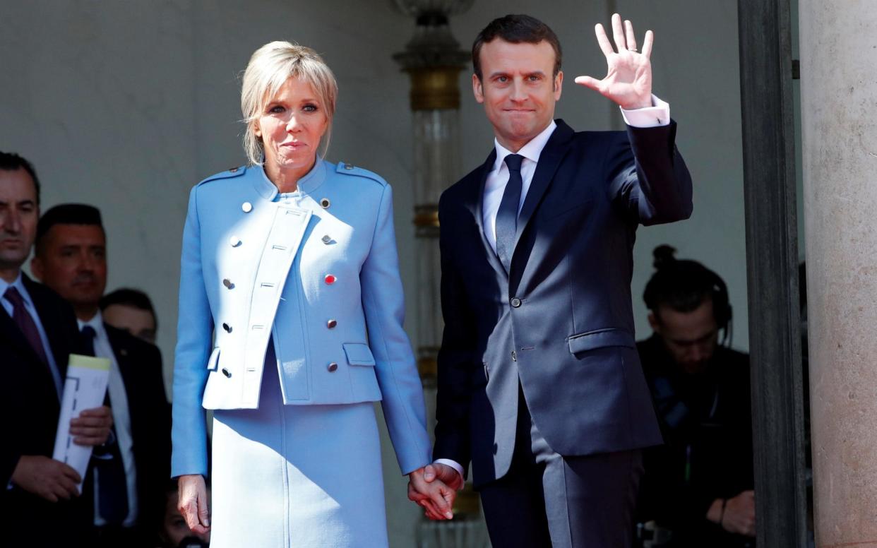French President Emmanuel Macron and his wife Brigitte Trogneux - REUTERS
