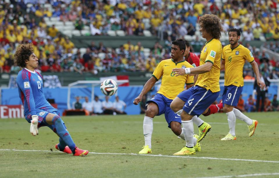 Mexico's Guillermo Ochoa (L-R) makes a save in front of Brazil's Paulinho, David Luiz and Fred during their 2014 World Cup Group A soccer match at the Castelao arena in Fortaleza June 17, 2014. (Sergio Moraes/Reuters)