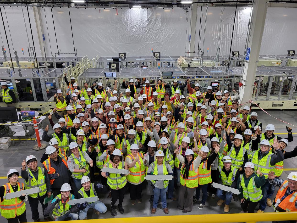Employees at the Ultium Cells LLC plant in Spring Hill, Tennessee, hold the first battery cells made at the plant which started production in March 2024. It will supply battery cells for General Motors' Cadillac Lyriq, which GM builds at its Spring Hill Assembly plant in Tennessee.