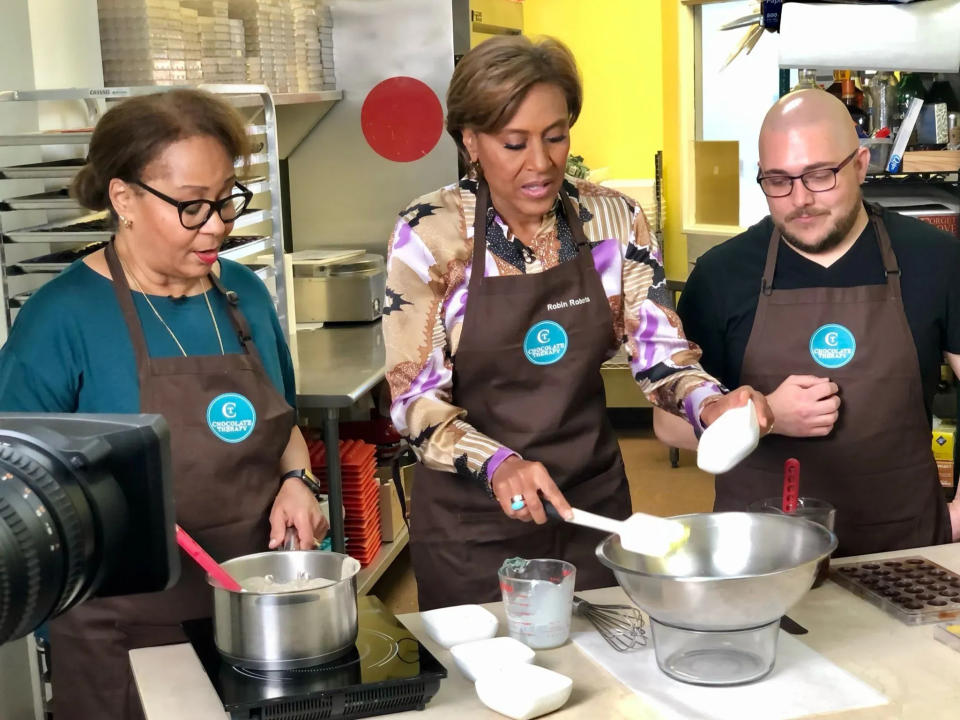 Robin Roberts, center, co-host at ABC's "Good Morning America," helped make chocolate during an October 2021 visit to Chocolate Therapy in Framingham. With her are Chocolate Therapy co-owner Pam Griffin, left, and chocolatier David Gemme.