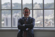 The skyline of Pittsburgh's north side is visible in the windows of the Energy Innovation Center as Andrew Wheeler, the EPA Administrator, listens as other officials speak about the rollback of the 2016 methane emissions rules to undo Obama-era rules designed to limit greenhouse gas emissions from oil and gas fields and pipelines at Thursday, Aug. 13, 2020, in Pittsburgh. (AP Photo/Keith Srakocic)