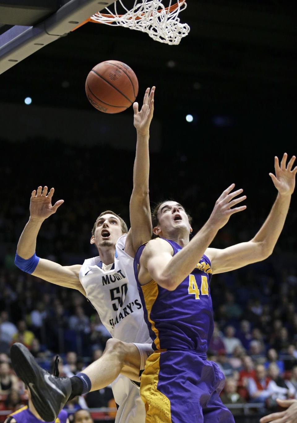 Mount St. Mary's center Taylor Danaher (50) goes up for a rebound against Albany center John Puk (44) in the second half of a first-round game of the NCAA college basketball tournament, Tuesday, March 18, 2014, in Dayton, Ohio. (AP Photo/Al Behrman)